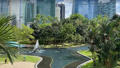 a park with a shark fountain in the middle of a city at KLCC City SkySuites in Kuala Lumpur