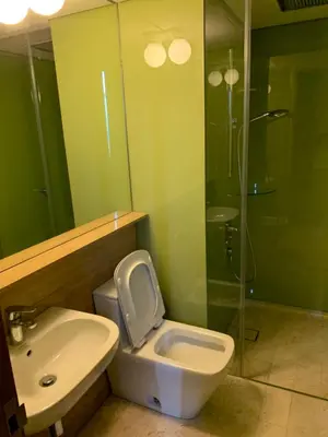 a bathroom with a toilet and a sink and a shower at KLCC City SkySuites in Kuala Lumpur