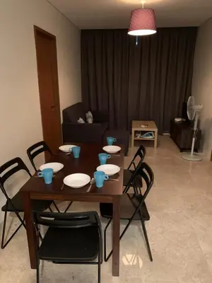 a table and chairs in a living room at KLCC City SkySuites in Kuala Lumpur