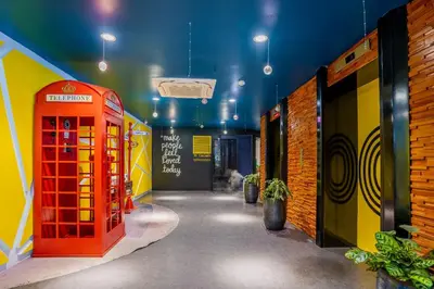a hallway with a red phone booth in a room at Hotel Olympic Malaysia Kuala Lumpur in Kuala Lumpur