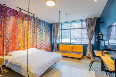 a bedroom with a swing bed and a chair at Hotel Olympic Malaysia Kuala Lumpur in Kuala Lumpur
