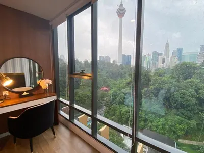 a room with a desk and a large window at Ceylonz Lifestyle Suites @ Bukit Bintang in Kuala Lumpur
