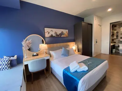 a bedroom with a bed and a desk with a chair at Ceylonz Lifestyle Suites @ Bukit Bintang in Kuala Lumpur