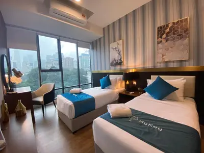 a hotel room with two beds and a window at Ceylonz Lifestyle Suites @ Bukit Bintang in Kuala Lumpur