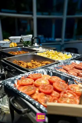 a buffet of food with tomatoes and other foods at Ceylonz Suites KLCC Rooftop Infinity Pool KL Tower View in Kuala Lumpur