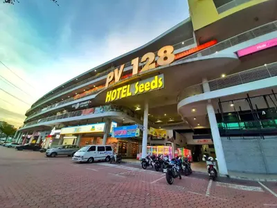 a building with motorcycles parked in a parking lot at Seeds Hotel PV128 Setapak in Kuala Lumpur
