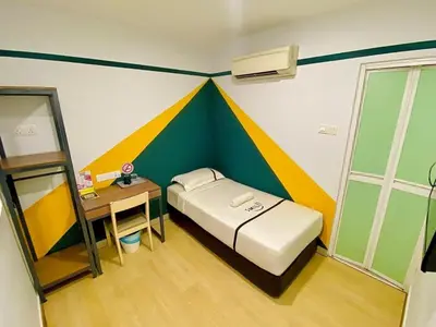 a bedroom with a bed with a colorful wall at Seeds Hotel PV128 Setapak in Kuala Lumpur