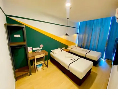 a small room with two beds and a table at Seeds Hotel PV128 Setapak in Kuala Lumpur