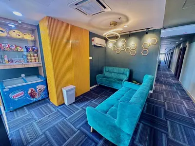 a waiting room with a couch and two chairs at Seeds Hotel PV128 Setapak in Kuala Lumpur