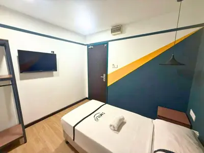 a small room with a bed and a tv at Smile Hotel Chow Kit PWTC in Kuala Lumpur