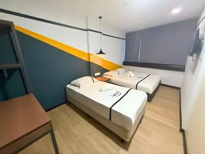 a room with two beds and a chalkboard at Smile Hotel Chow Kit PWTC in Kuala Lumpur