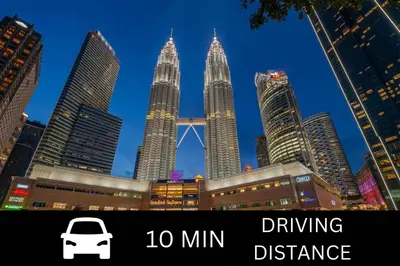 a white car parked in front of tall buildings at Smile Hotel Chow Kit PWTC in Kuala Lumpur