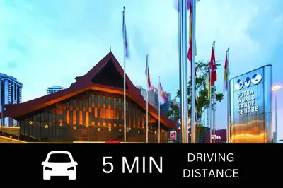a car parked in front of a building with flags at Smile Hotel Chow Kit PWTC in Kuala Lumpur