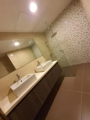 a bathroom with two sinks and a mirror at Regalia Residence KLCC View by iLuxHome in Kuala Lumpur