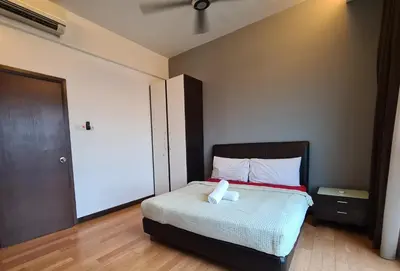 a bedroom with a bed with a towel on it at Regalia Residence KLCC View by iLuxHome in Kuala Lumpur