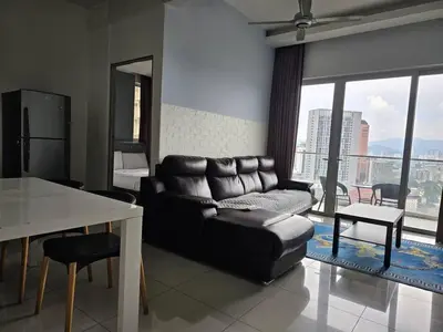 a living room with a leather couch and a table at Regalia Residence KLCC View by iLuxHome in Kuala Lumpur