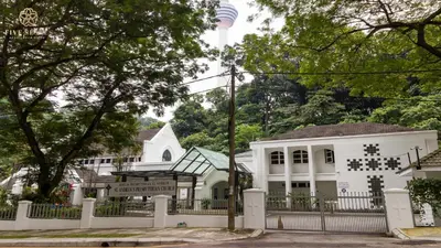 a white house with a fence in front of it at Ceylonz Suites Kuala Lumpur, Roam in Kuala Lumpur