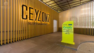 a room with a yellow wall with a sign on it at Ceylonz Suites Kuala Lumpur, Roam in Kuala Lumpur