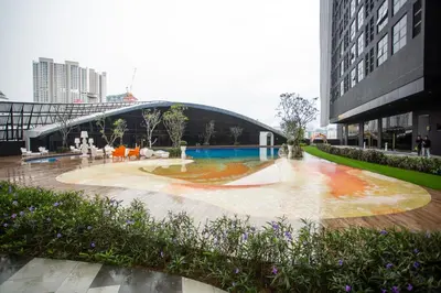 a building with a fountain in the middle of a courtyard at ARTE MONT KIARA BY PSM Luxury Suites in Kuala Lumpur