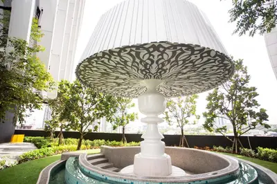 a mushroom sculpture in front of a building at ARTE MONT KIARA BY PSM Luxury Suites in Kuala Lumpur