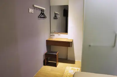 a bathroom with a sink and a mirror at Rain Forest Hotel in Kuala Lumpur
