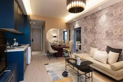a kitchen and living room with a couch and a table at AMI Suites - Arte Mont Kiara in Kuala Lumpur
