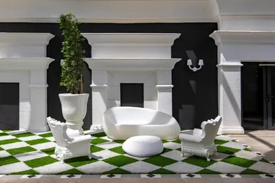 a living room with a white couch and two chairs at AMI Suites - Arte Mont Kiara in Kuala Lumpur