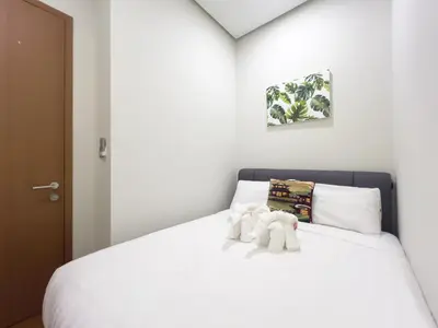 two stuffed elephants sitting on top of a bed at Soho Suites KLCC by GuestHouse in Kuala Lumpur