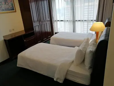 a hotel room with two beds and a lamp at KL Time Square suit At Times square in Kuala Lumpur