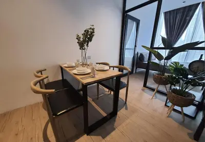 a dining room with a table and chairs with flowers on it at Bangsar Trade Centre Kuala Lumpur by SkyLimit Suites in Kuala Lumpur
