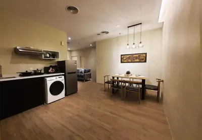 a kitchen and dining room with a table and a washer at Bangsar Trade Centre Kuala Lumpur by SkyLimit Suites in Kuala Lumpur