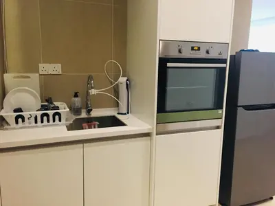 a small kitchen with a sink and a refrigerator at KLGateway Premium Residence Mid Valley in Kuala Lumpur