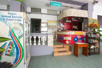 a store with a counter and stairs in a room at SPOT ON 90137 Casavilla Hotel Pudu in Kuala Lumpur