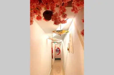 a hallway with white walls and red flowers on the ceiling at Fahrenheit88-Japan Theme Bukit Bintang Kuala Lumpur 2R2B 6Pax in Kuala Lumpur