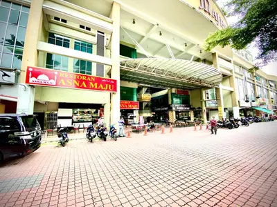 a mall with motorcycles parked in front of a building at Monkey Mansion in Kuala Lumpur