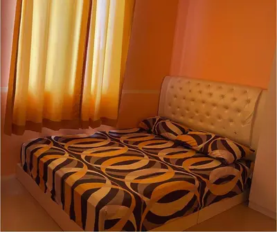 a bed sitting in a room next to a window at Monkey Mansion in Kuala Lumpur