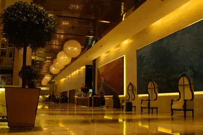 a lobby with two chairs in a building at Luxe Suites at Platinum KLCC in Kuala Lumpur
