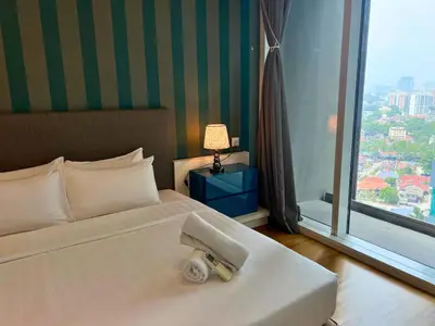 a hotel room with a bed and a large window at Luxe Suites at Platinum KLCC in Kuala Lumpur