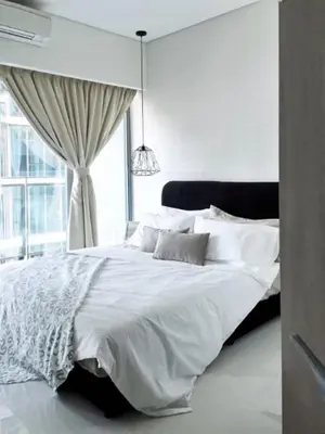 a white bed in a bedroom with a window at Signature Apartment at Mercu Summer Suites KLCC in Kuala Lumpur