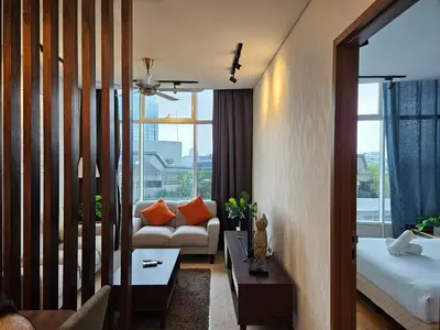 a hotel room with a bed and a couch and a window at Sky Suites KLCC by Asiapex in Kuala Lumpur