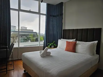 a bedroom with a large bed with a large window at Sky Suites KLCC by Asiapex in Kuala Lumpur