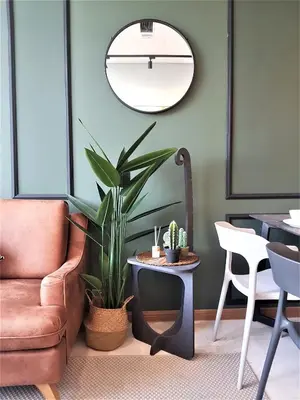 a living room with a chair and a table with a plant at Sky Suites KLCC by Asiapex in Kuala Lumpur