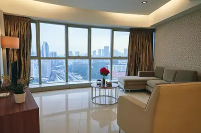 a living room with a couch and a large window at Wonderful KLCC View at Regalia Suites in Kuala Lumpur