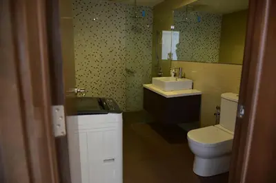 a bathroom with a toilet and a sink at Wonderful KLCC View at Regalia Suites in Kuala Lumpur