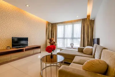 a living room with a couch and a tv at Wonderful KLCC View at Regalia Suites in Kuala Lumpur