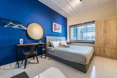 a bedroom with blue walls and a bed and a desk at 3BR Family-Friendly Landed House,PandanPerdana,KL by Verano in Kuala Lumpur