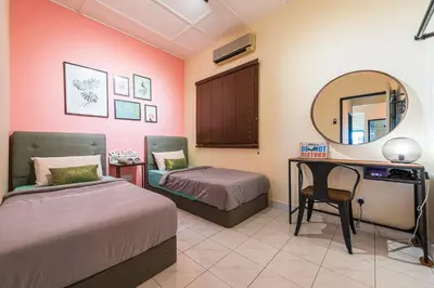 a bedroom with two beds and a mirror and a desk at 3BR Family-Friendly Landed House,PandanPerdana,KL by Verano in Kuala Lumpur