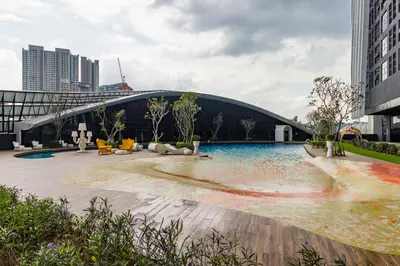 a building with a pool in the middle of a city at Arte Mont Kiara in Kuala Lumpur