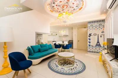 a living room with a blue couch and a table at Arte Mont Kiara in Kuala Lumpur