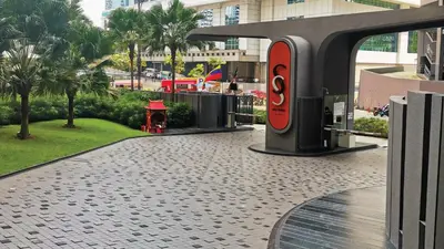 a red fire hydrant on a sidewalk in a city at Sky Suites KLCC by iRent365 in Kuala Lumpur